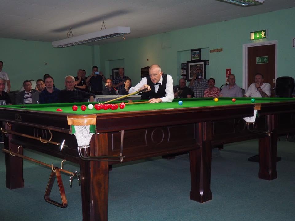 Steve Davis playing a shot at Sudbury Snooker Club, watched by spectators.